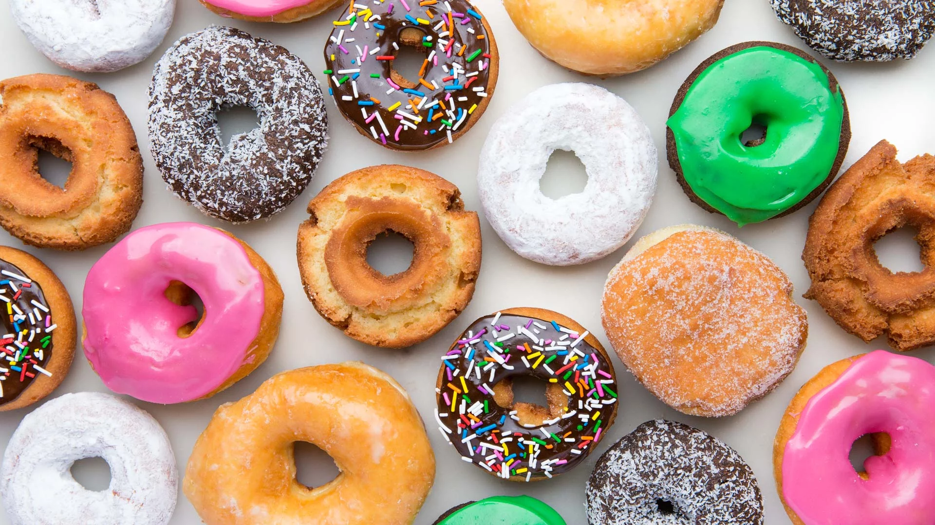 A vibrant array of Lee's Donuts showcasing an assortment of colors, toppings, and unique designs appealing to the sweet-loving audience.