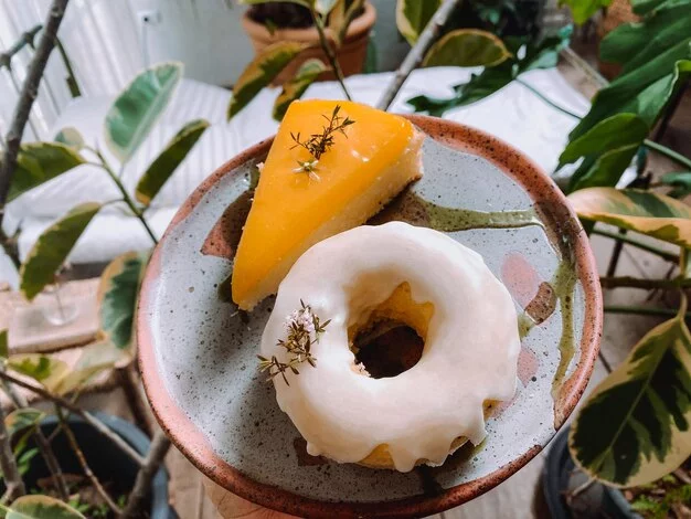 A close-up of a classic honey-dip donut with a shiny glaze.